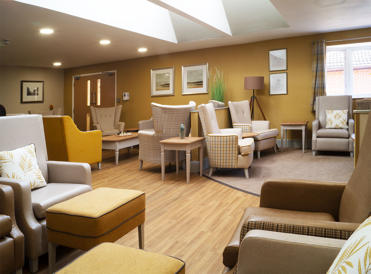A bright, comfortable Riverside lounge with armchairs and natural light